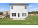 Well-maintained backyard with a patio, green lawn, and view of the home's exterior at 492 Switch St # 82 Ty, York, SC 29745