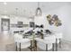 Open-concept dining area with a glass table, seating for six, and modern decor, seamlessly connected to the kitchen at 492 Switch St # 82 Ty, York, SC 29745