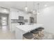Bright kitchen features quartz countertops, stainless steel appliances, pendant lighting, and a large island with seating at 492 Switch St # 82 Ty, York, SC 29745