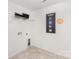Practical laundry room with shelving, utility hookups and instructional wall decor at 492 Switch St # 82 Ty, York, SC 29745