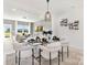 Bright dining room with modern chandelier over glass table and views into the living room at 492 Switch St # 82 Ty, York, SC 29745