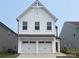 Charming two-story home featuring a white exterior, a two-car garage, and modern architectural details at 492 Switch St # 82 Ty, York, SC 29745