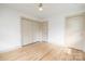 Bedroom featuring hardwood floors, neutral walls, and closet space, offering modern comfort at 4929 Prentice Pl, Charlotte, NC 28210