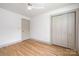 Empty bedroom with hardwood floors, neutral walls, and closet, ready for your personal touch at 4929 Prentice Pl, Charlotte, NC 28210