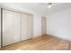 Bedroom with hardwood floors, neutral walls, and closet doors for a cozy atmosphere at 4929 Prentice Pl, Charlotte, NC 28210