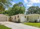 Side view of a beautiful one-story house with white painted brick, a detached garage, and a concrete driveway at 4929 Prentice Pl, Charlotte, NC 28210