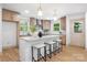 Well-lit kitchen with marble countertops, a white kitchen island, and stainless steel appliances at 4929 Prentice Pl, Charlotte, NC 28210