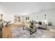 Bright living room featuring hardwood floors, neutral tones, a modern sofa, and lots of natural light at 4929 Prentice Pl, Charlotte, NC 28210