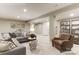 Finished basement area features a large grey sectional couch, leather armchair, and neutral carpet at 524 Lenswood Ct, Denver, NC 28037