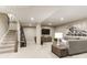 Finished basement featuring a carpeted staircase, a living area with a couch and a TV at 524 Lenswood Ct, Denver, NC 28037