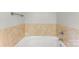 Bright bathroom featuring a white jacuzzi tub with tile surround at 5410 Berryview Ln, Gastonia, NC 28056