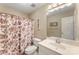 Traditional bathroom with sink, toilet, and floral shower curtain at 5410 Berryview Ln, Gastonia, NC 28056
