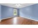 This bedroom has laminate floors, a fan and a window at 5410 Berryview Ln, Gastonia, NC 28056