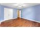 Bedroom with laminate floors, a ceiling fan, and double closets at 5410 Berryview Ln, Gastonia, NC 28056