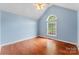 Bedroom with a window, ceiling fan, and hardwood floors at 5410 Berryview Ln, Gastonia, NC 28056