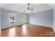 Serene bedroom offers two windows and hardwood floors for a peaceful retreat at 5410 Berryview Ln, Gastonia, NC 28056