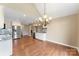 Inviting dining area with hardwood floors, modern lighting, and stainless steel appliances at 5410 Berryview Ln, Gastonia, NC 28056