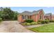 Lovely brick home featuring a side entry driveway, mature landscaping, and classic architectural details at 5410 Berryview Ln, Gastonia, NC 28056
