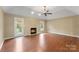 Spacious living room features a cozy fireplace, hardwood floors, and a ceiling fan at 5410 Berryview Ln, Gastonia, NC 28056