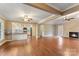 Open-concept living space with hardwood floors, a fireplace, and a kitchen featuring granite counters and stainless steel appliances at 5410 Berryview Ln, Gastonia, NC 28056