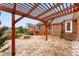 Stone patio area with a fire pit and wood pergola at 5410 Berryview Ln, Gastonia, NC 28056