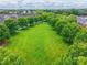 Aerial view showcasing a large grassy common area with mature trees and an American flag at 5623 Fetzer Nw Ave, Concord, NC 28027