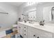 Bathroom features double sinks, white cabinets, large mirror, and neutral tile floors at 5623 Fetzer Nw Ave, Concord, NC 28027