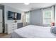 Inviting bedroom features a large wall-mounted television and lots of natural light at 5623 Fetzer Nw Ave, Concord, NC 28027