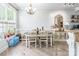 Inviting dining room featuring a classic table with seating and a window for natural lighting at 5623 Fetzer Nw Ave, Concord, NC 28027