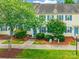 Inviting townhome with charming curb appeal, featuring a landscaped front yard and blue shutters at 5623 Fetzer Nw Ave, Concord, NC 28027