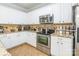 Well-lit kitchen with white cabinetry, granite countertops, and a range of modern appliances at 5623 Fetzer Nw Ave, Concord, NC 28027