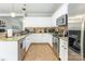 Bright kitchen with white cabinets, granite countertops, stainless steel appliances and tile flooring at 5623 Fetzer Nw Ave, Concord, NC 28027