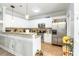 Modern kitchen with white cabinets, granite countertops, and stainless steel appliances at 5623 Fetzer Nw Ave, Concord, NC 28027
