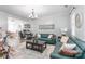 Inviting living room featuring stylish blue leather sofas, a modern chandelier, and neutral decor at 5623 Fetzer Nw Ave, Concord, NC 28027