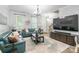 Cozy living room featuring stylish blue leather sofas, a modern TV, and neutral decor at 5623 Fetzer Nw Ave, Concord, NC 28027