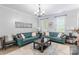 Bright living room showcasing two blue leather sofas, a decorative clock, and elegant furnishings at 5623 Fetzer Nw Ave, Concord, NC 28027