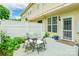 Cozy patio area with outdoor dining, white fence, and access to the house at 5623 Fetzer Nw Ave, Concord, NC 28027