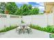 Private outdoor patio with white fence, seating, and lush greenery perfect for relaxing at 5623 Fetzer Nw Ave, Concord, NC 28027