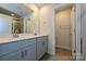 En suite bathroom with double sink vanity, tile floor, and a glass enclosed shower at 7028 Alva Ter, Charlotte, NC 28216