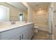 A luxurious primary bathroom features a dual sink vanity, a large mirror and a shower and tub at 7028 Alva Ter, Charlotte, NC 28216