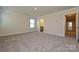 Primary bedroom featuring neutral paint, carpet and an en suite bathroom at 7028 Alva Ter, Charlotte, NC 28216
