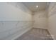 Walk-in closet with wire shelving and carpeted floor at 7028 Alva Ter, Charlotte, NC 28216