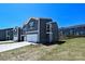 Modern townhome exterior with gray siding, white trim, and an attached garage on a sunny day at 7028 Alva Ter, Charlotte, NC 28216