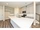 Modern kitchen with gray cabinets, a white countertop island, and stainless steel appliances at 7028 Alva Ter, Charlotte, NC 28216