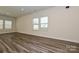 Bright living room featuring laminate floors, neutral walls, and ample natural light at 7028 Alva Ter, Charlotte, NC 28216