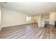 Bright living room featuring laminate floors, neutral walls, and ample natural light at 7028 Alva Ter, Charlotte, NC 28216