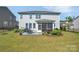 Spacious backyard with a patio dining set and screened in porch, surrounded by landscaped gardens and fencing at 7046 North Bridge Dr, Huntersville, NC 28078