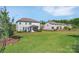 Expansive backyard featuring a lush lawn and cozy patio with a screened-in porch, perfect for outdoor enjoyment at 7046 North Bridge Dr, Huntersville, NC 28078