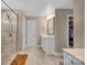 A tiled bathroom with a glass shower and an adjoining walk-in closet at 7046 North Bridge Dr, Huntersville, NC 28078