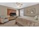 Comfortable bedroom featuring a TV and a wood accent wall at 7046 North Bridge Dr, Huntersville, NC 28078
